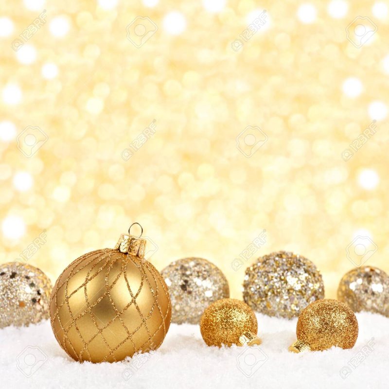 Golden Christmas Ornaments In Snow With Twinkling Gold Background Stock  Photo, Picture And Royalty Free Image. Image 116848530.